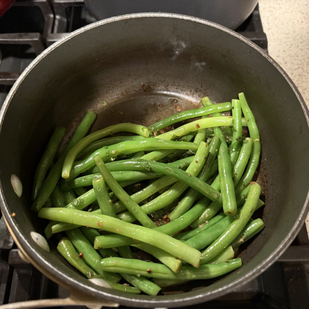 Green beans with lemon and mint in the sauce pan